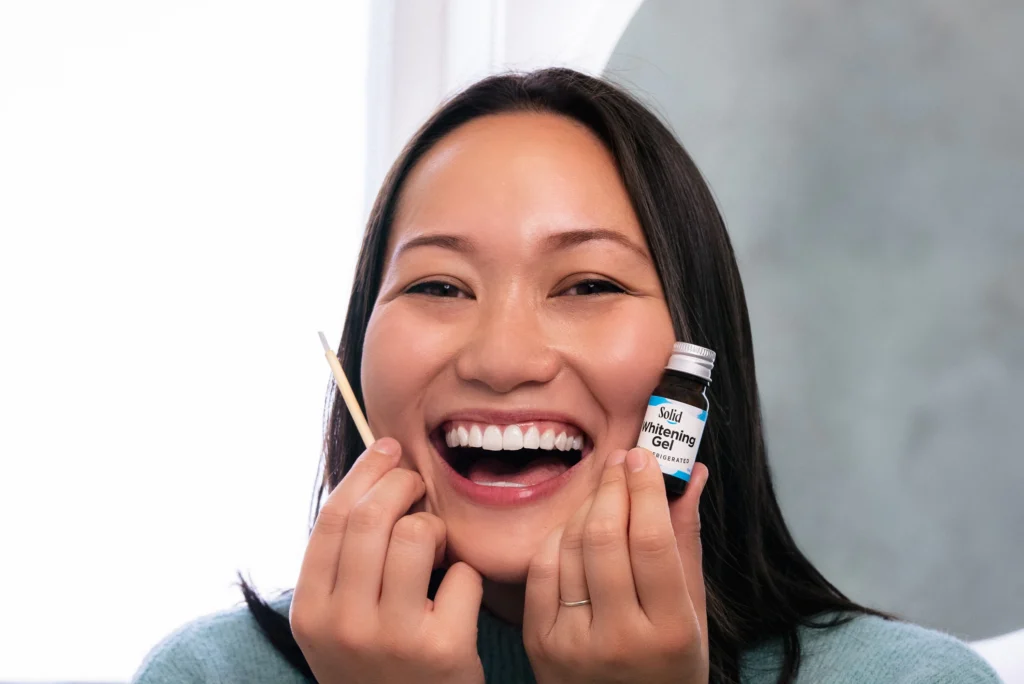 Person smiling, white teeth, Solid's teeth whitening gel. How does teeth whitening work?